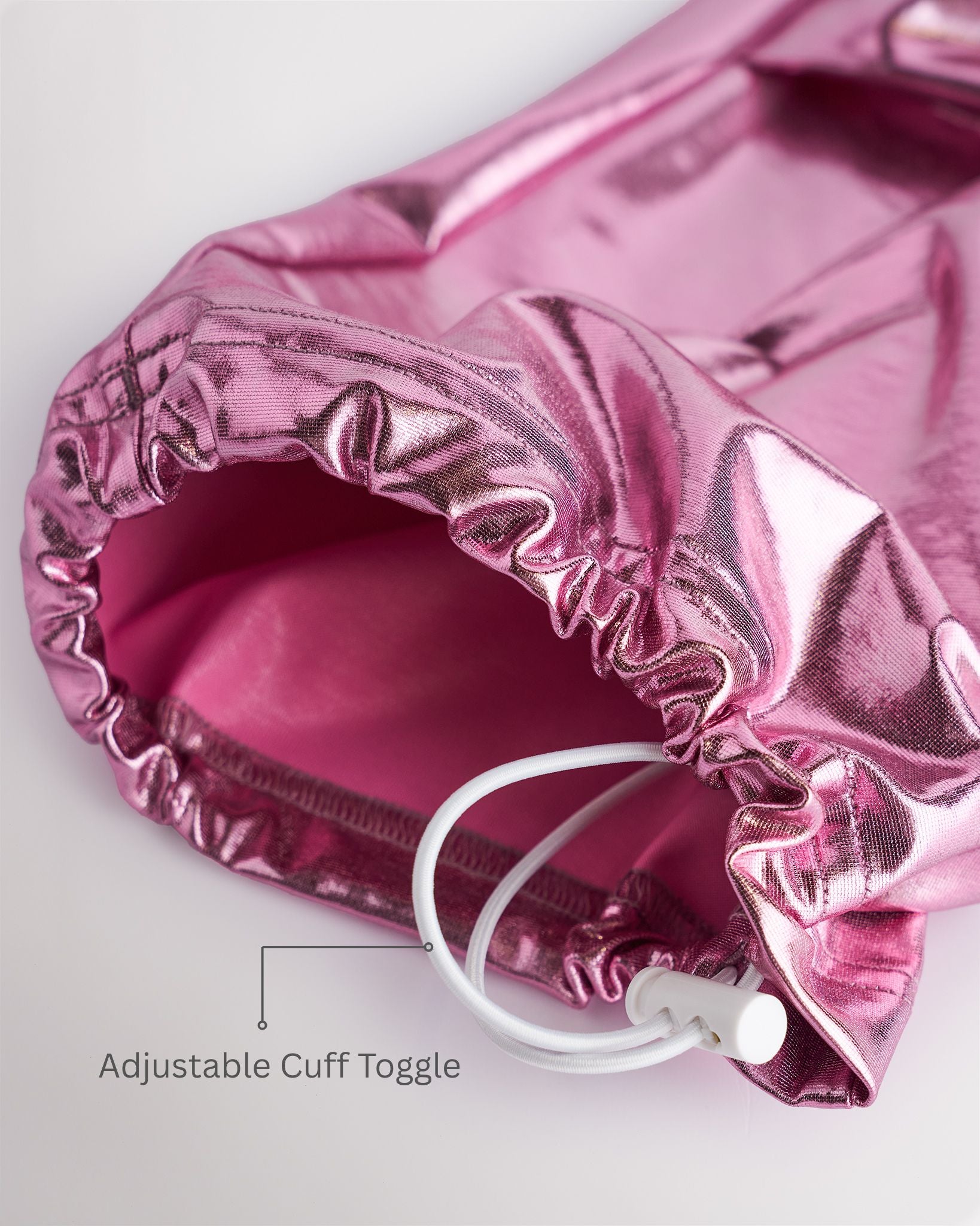 Close-up of metal pink girls cargo pants showing the adjustable cuff toggle at the hem for switching between wide-leg and tapered jogger styling.