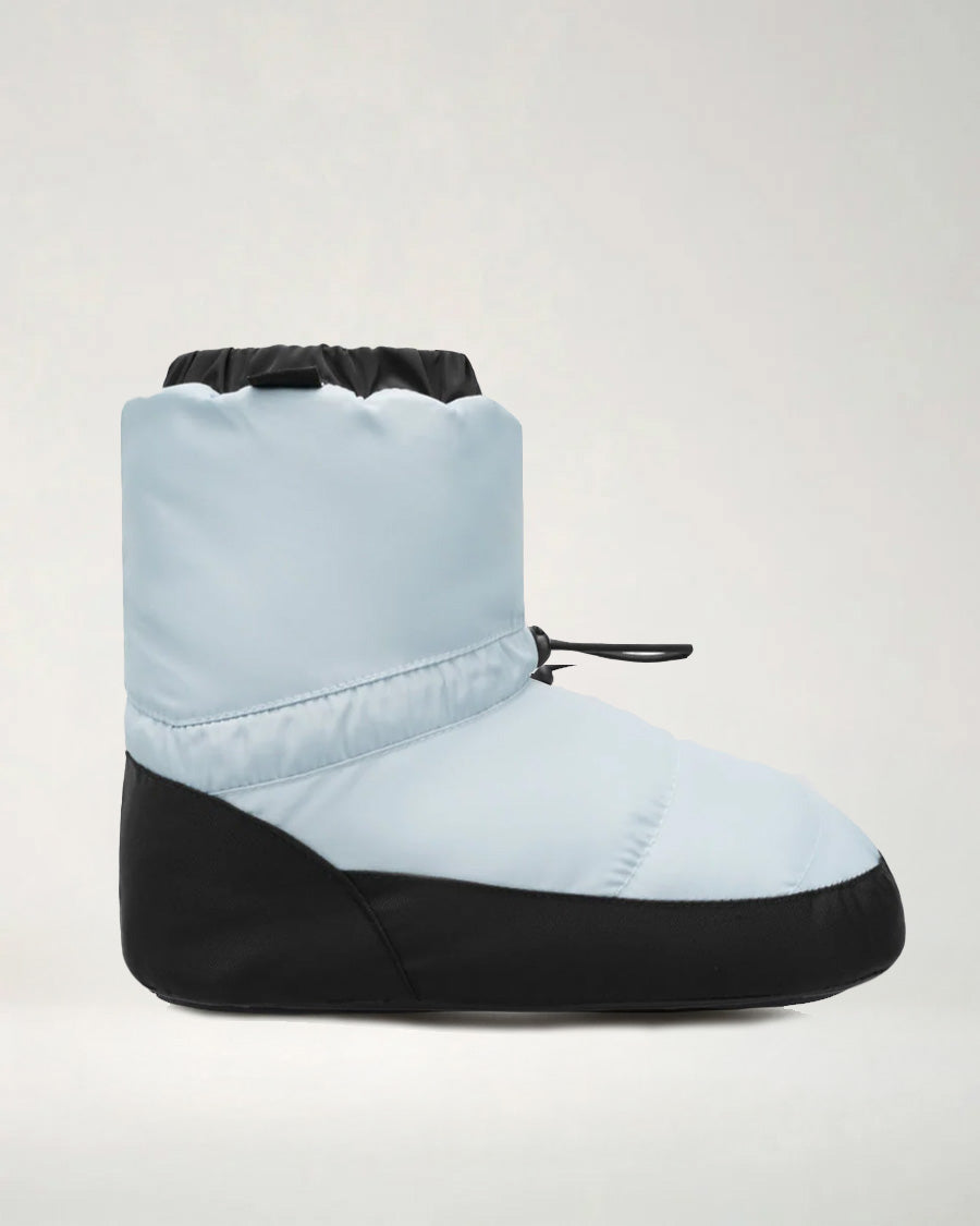 A kid's ballet bootie with a blue upper and black non-slip sole, featuring an elastic cuff and drawstring.