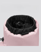 Close-up of a pink jacket with black interior lining on a light gray background