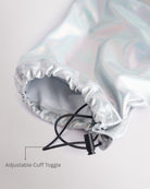 Close-up of holographic silver girls cargo pants showing the adjustable cuff toggle at the hem for switching between wide-leg and tapered jogger styling.