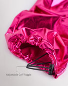 Close-up of metal fuchsia girls cargo pants showing the adjustable cuff toggle at the hem for switching between wide-leg and tapered jogger styling.