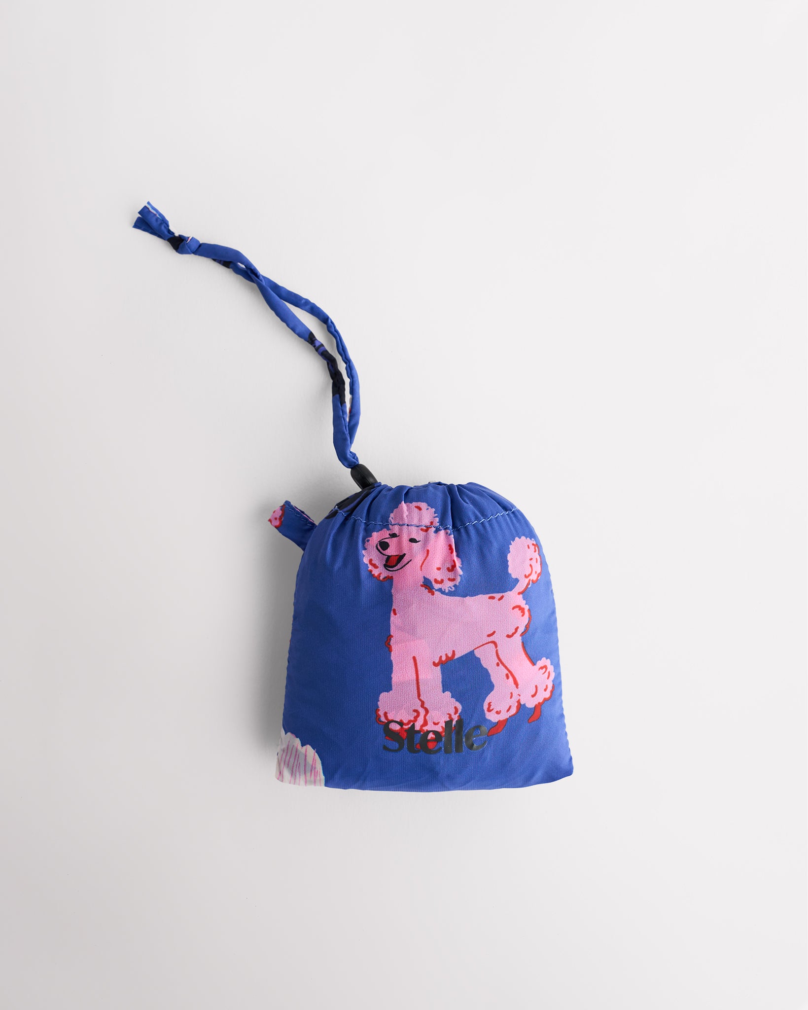 Folded Puppy Parade on Blue Stelle reusable grocery bag in attached pouch with puppy print and clip-on loop for compact storage.