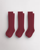 Three pairs of red kids ribbed calf socks with supportive no-slip fit and seamless toe design for school and everyday wear.