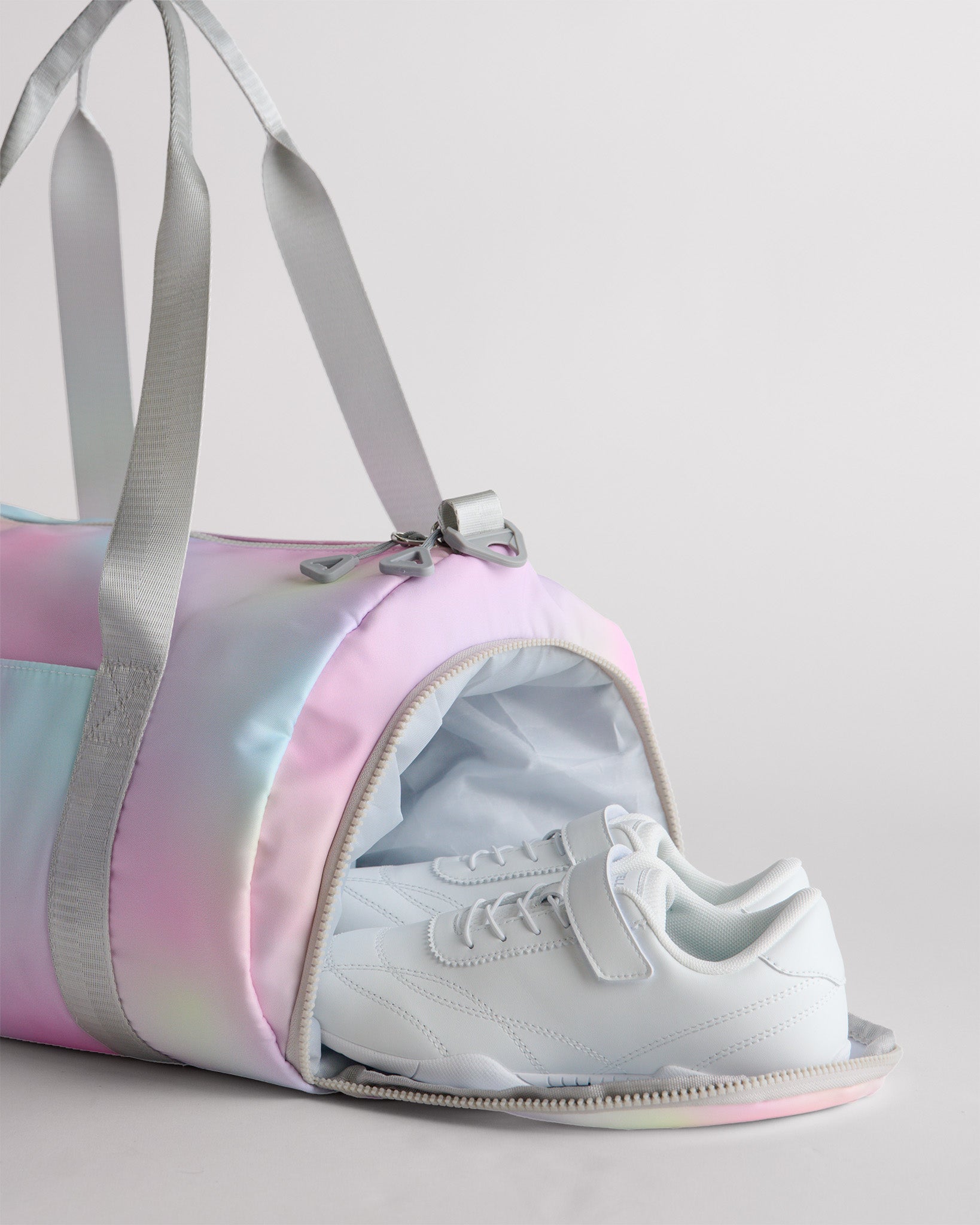 Gym duffle bag with separate shoe compartment holding sneakers for clean and organized packing