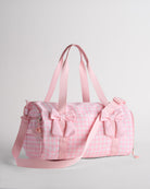 Pink gingham kids duffle bag with bow details, top handles and adjustable shoulder strap for dance and travel.