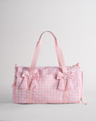 Kids pink gingham duffle bag with bows and spacious main compartment designed for sports and dance essentials.