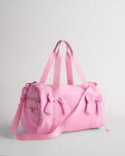 Taffy Pink kids duffle bag with bow details, top handles and adjustable shoulder strap for dance and travel.