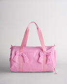 Kids taffy pink duffle bag with bows and spacious main compartment designed for sports and dance essentials.