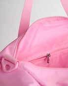 Taffy Pink duffle bag interior with zip pocket and organized storage compartments for small items