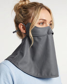 Woman wearing a grey UPF 50+ sun protection face mask with full neck coverage, adjustable ear loops, and secure back fit.