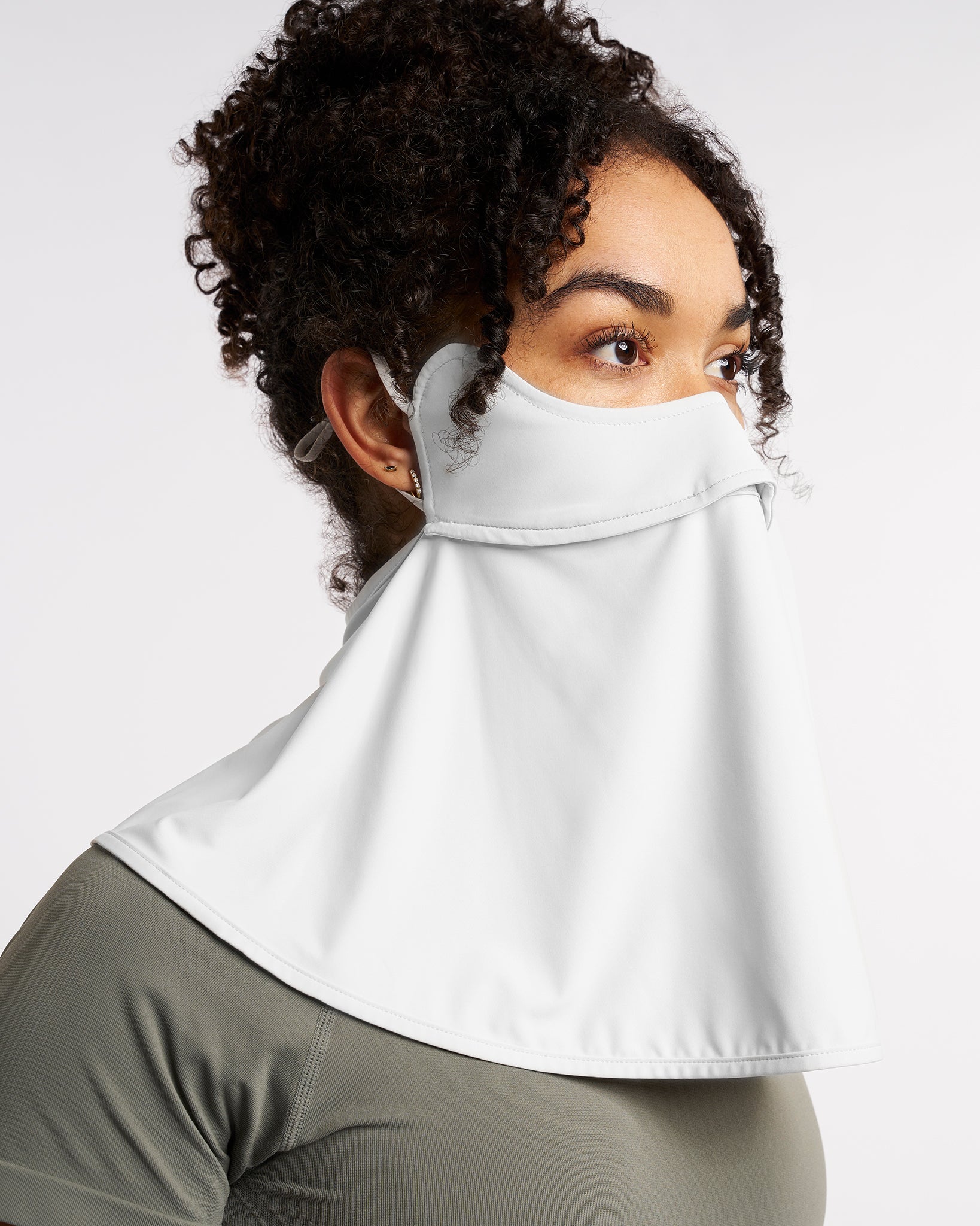Woman wearing a white UPF 50+ sun protection face mask with full neck coverage, adjustable ear loops, and secure back fit.