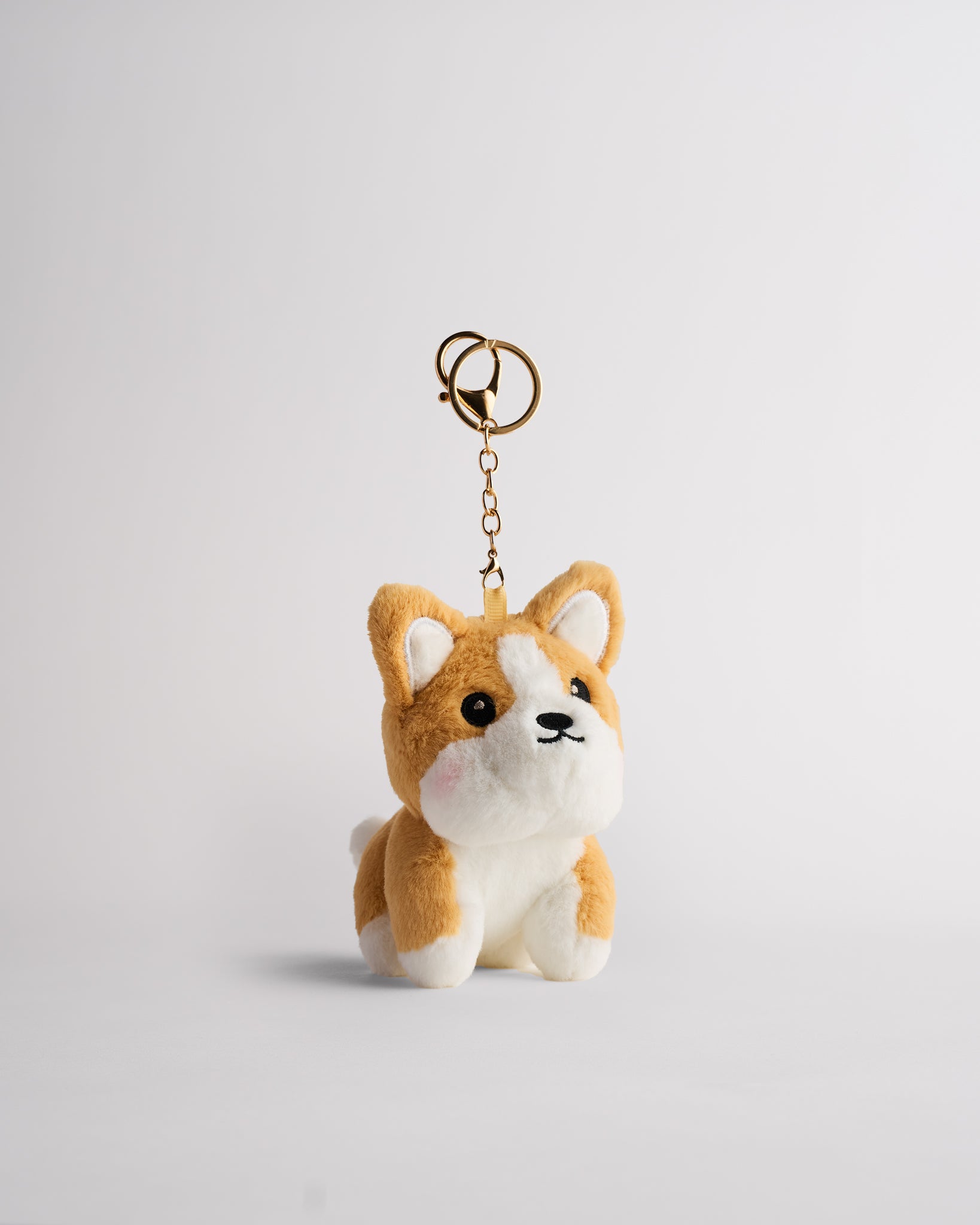 Stelle Charlie Corgi plush keychain with gold key ring, quick-release metal clip, and embroidered corgi details.