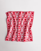 Magic Self-Adhesive Wrapper Essential Bag with red and pink heart and bow print, shown slightly folded