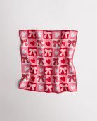 Magic Self-Adhesive Wrapper Essential Bag with red and pink heart and bow print, shown slightly folded