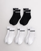 Five pairs of kids socks in black and white with sporty stripes and lettuce-edge ruffle cuffs