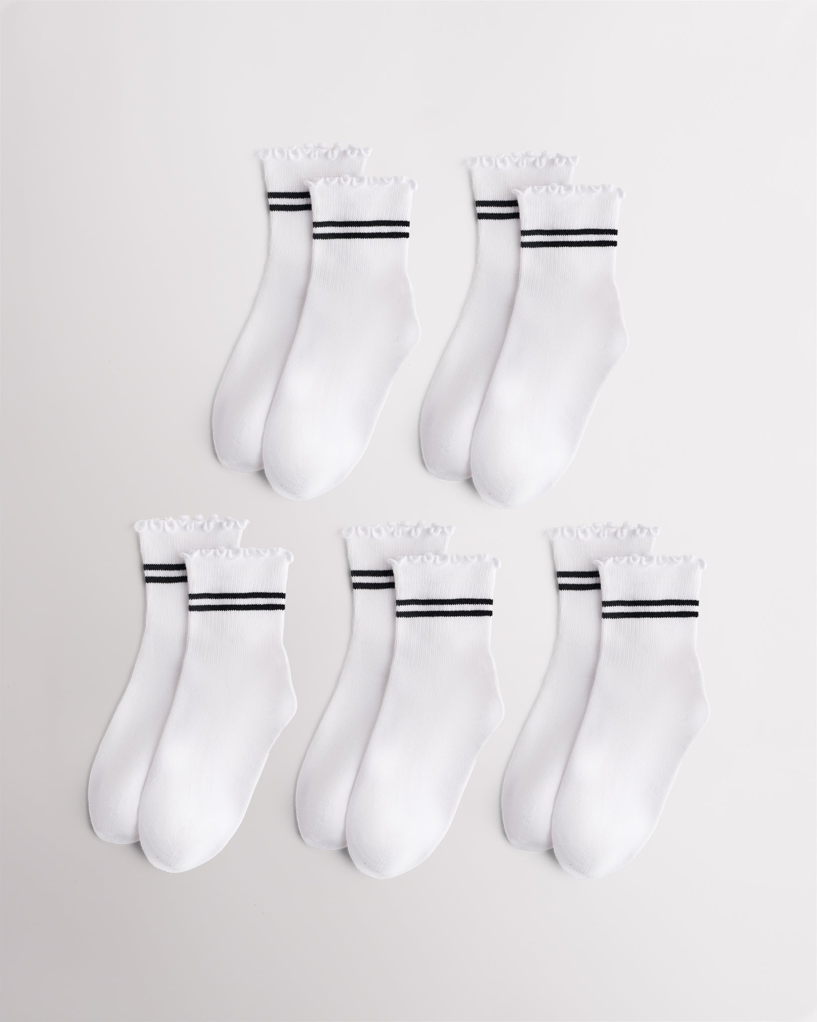 Five pairs of white Stelle kids socks with black sporty stripes and lettuce-edge cuffs
