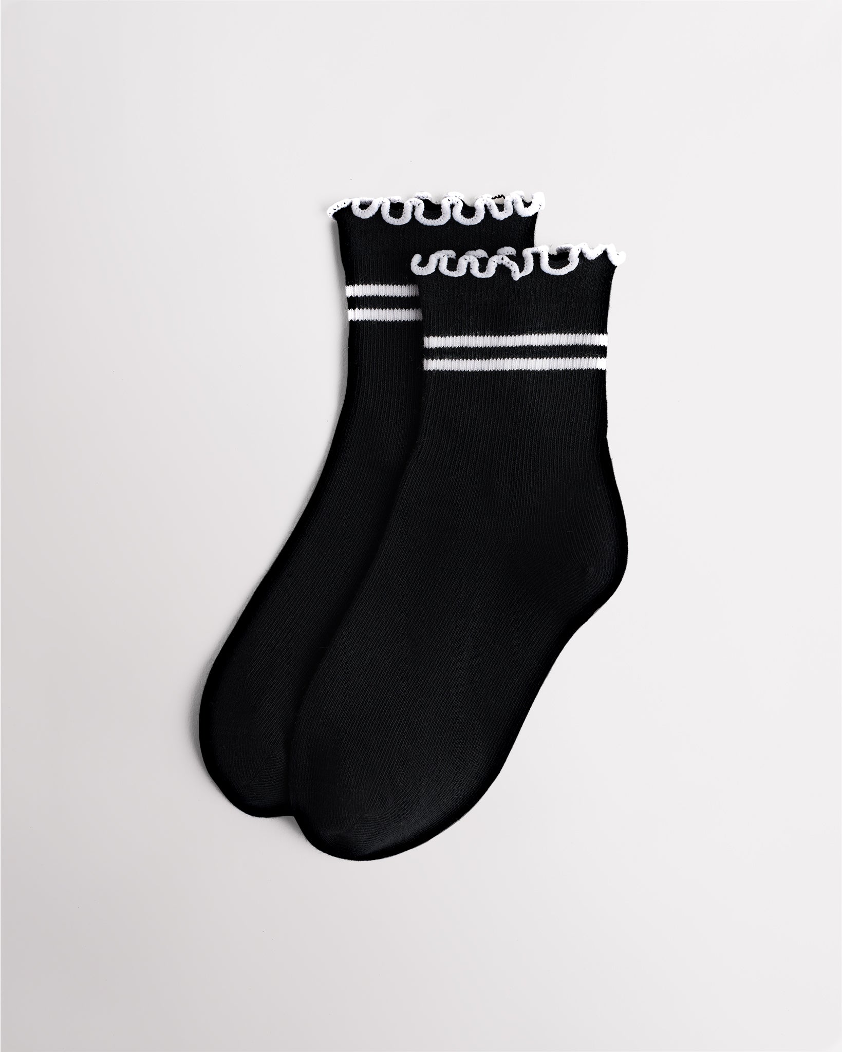 Black Stelle Kids Lettuce-Edge Stripes Socks with white stripes, ribbed cuffs, and ruffle trim