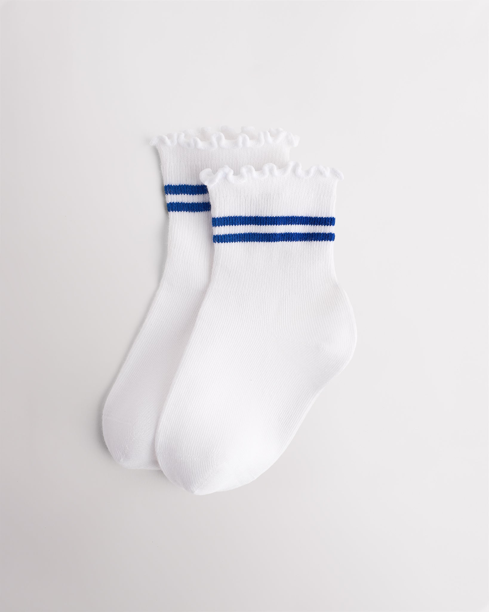 White kids socks with blue sporty stripes, ribbed cuffs, and lettuce-edge ruffle trim