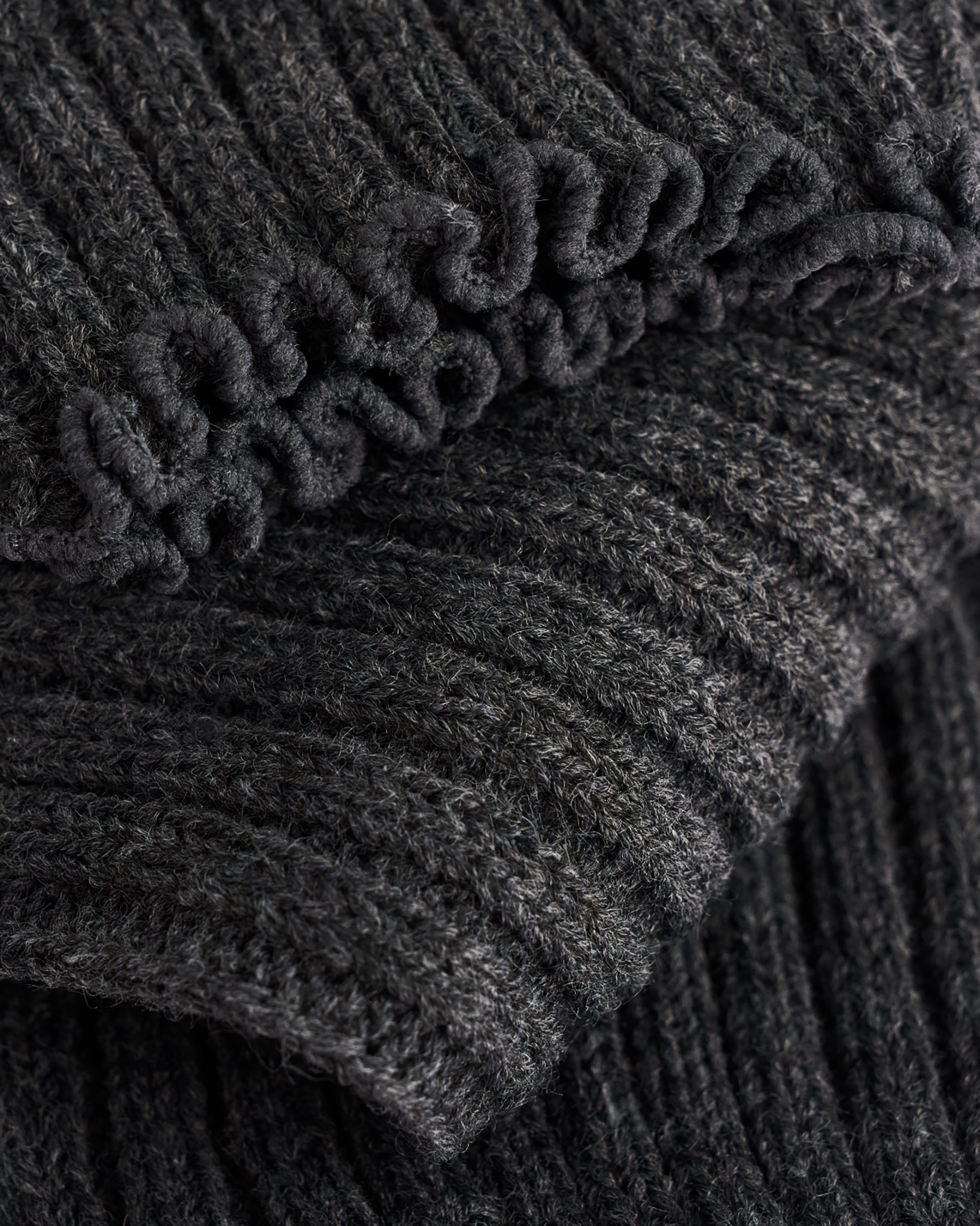 Close-up of Heather Charcoal ballet leg warmers showing soft knit texture and delicate lettuce-edge trim.