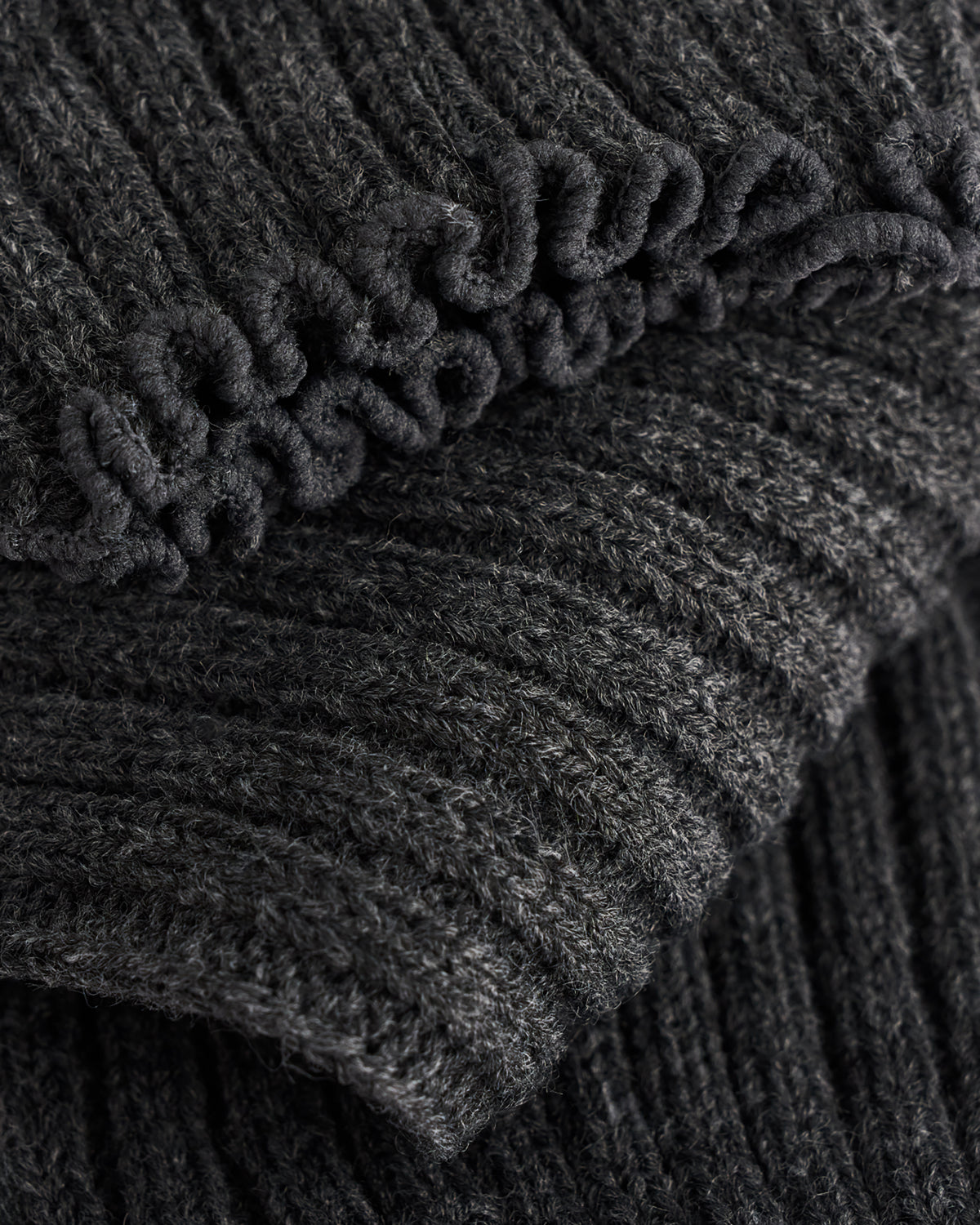 Close-up of Heather Charcoal ballet leg warmers showing soft knit texture and delicate lettuce-edge trim.