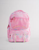 Front view of pink backpack for kids with rainbow pattern, mesh pocket, buckle straps, and multiple zipper pockets.