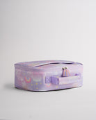 Side view of lavender Stelle lunch bag with rainbow zipper pulls, soft-sided shape, and easy-carry handle.