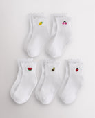 Five-pack white kids ruffle socks with embroidered fruit motifs, lettuce-edge trim, ribbed crew length, and shaped heel.
