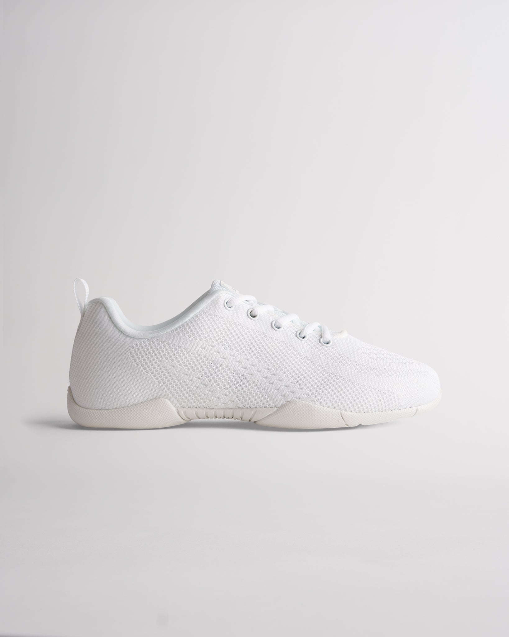White cheer shoes with knit upper, lace-up design and flexible sole for training and performance