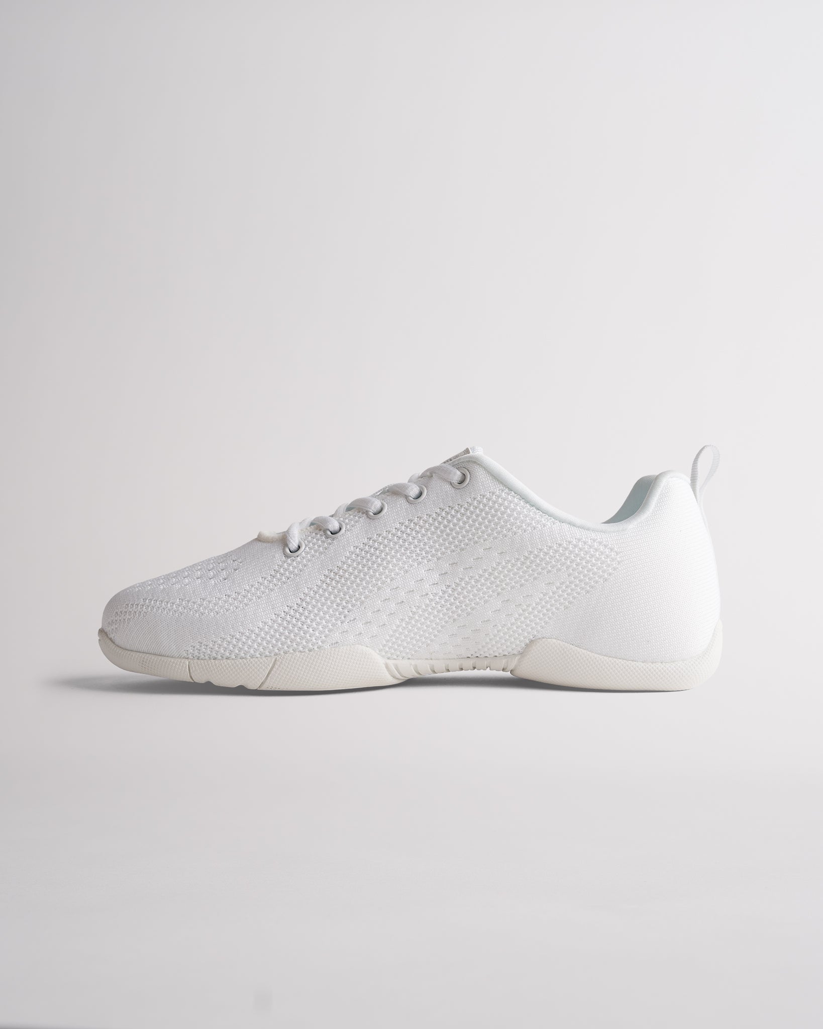Lightweight white cheer shoes featuring breathable knit material and supportive athletic design