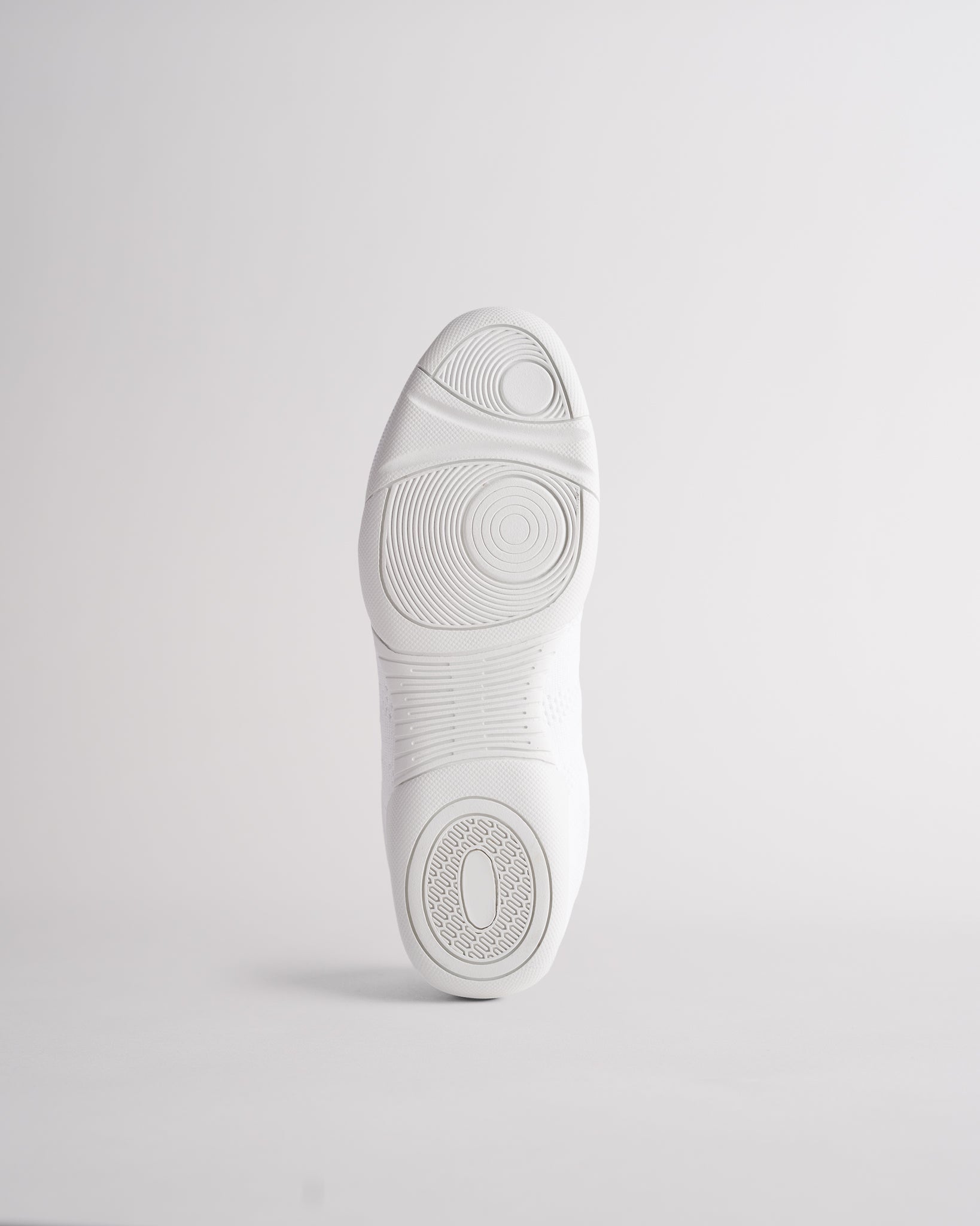 Bottom sole of white cheer shoes showing traction pattern for grip and stability during cheer routines