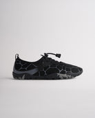 Black women’s water shoes with mesh upper and speed lace system, side profile view