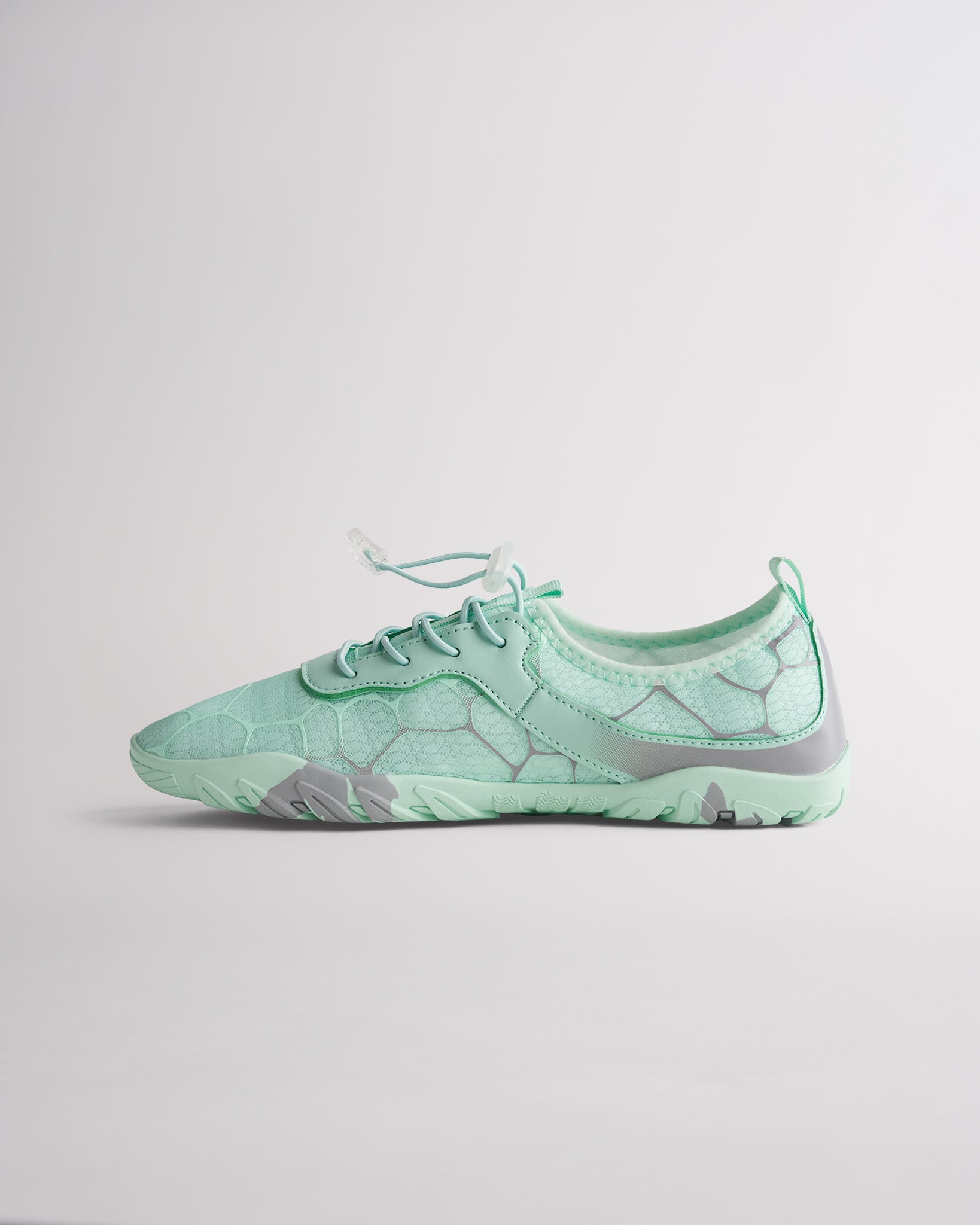 Angled view of mint green womens water shoes showing breathable mesh and flexible sole