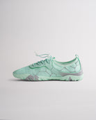 Angled view of mint green womens water shoes showing breathable mesh and flexible sole