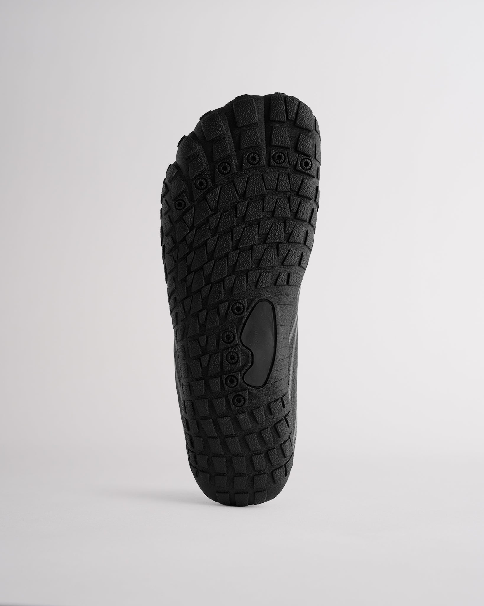Bottom view of water shoes with textured traction outsole and drainage holes