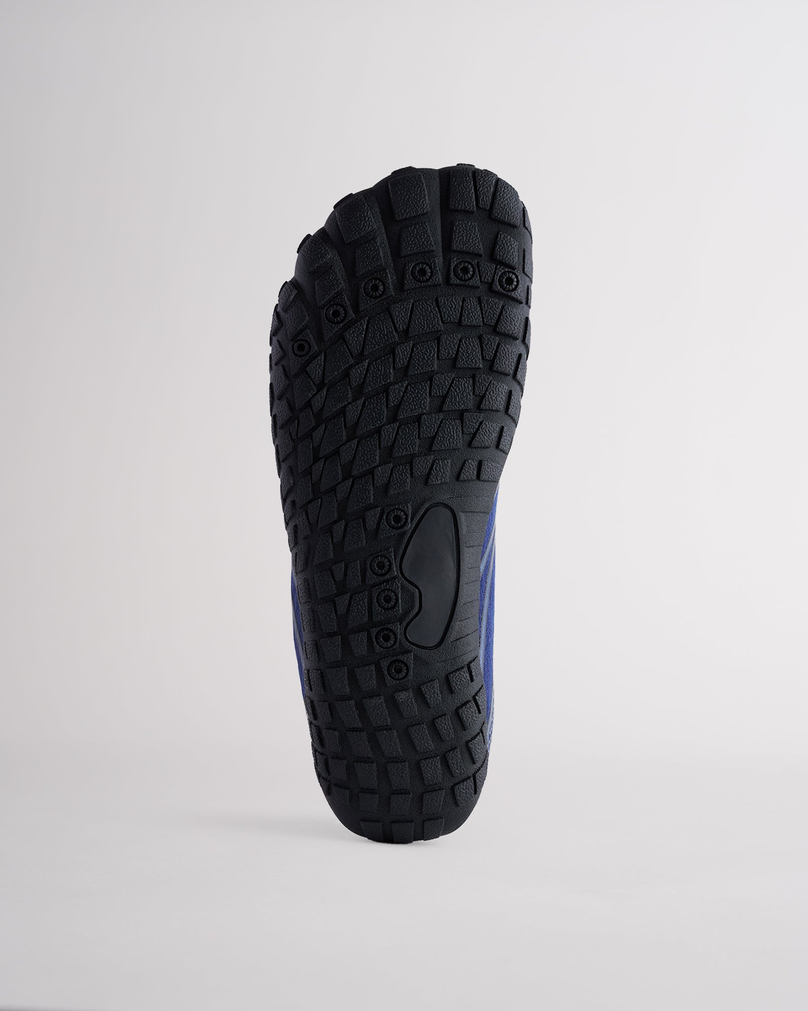 Bottom view of water shoes with textured traction outsole and drainage holes