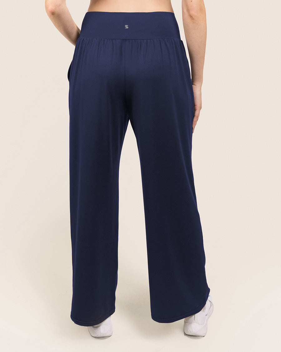 Navy blue wide-leg pants worn by a person on a beige background