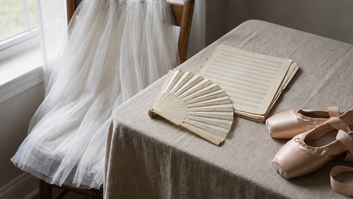 Objects from the history of ballet: fan, sheet music, romantic tutu and pointe shoes