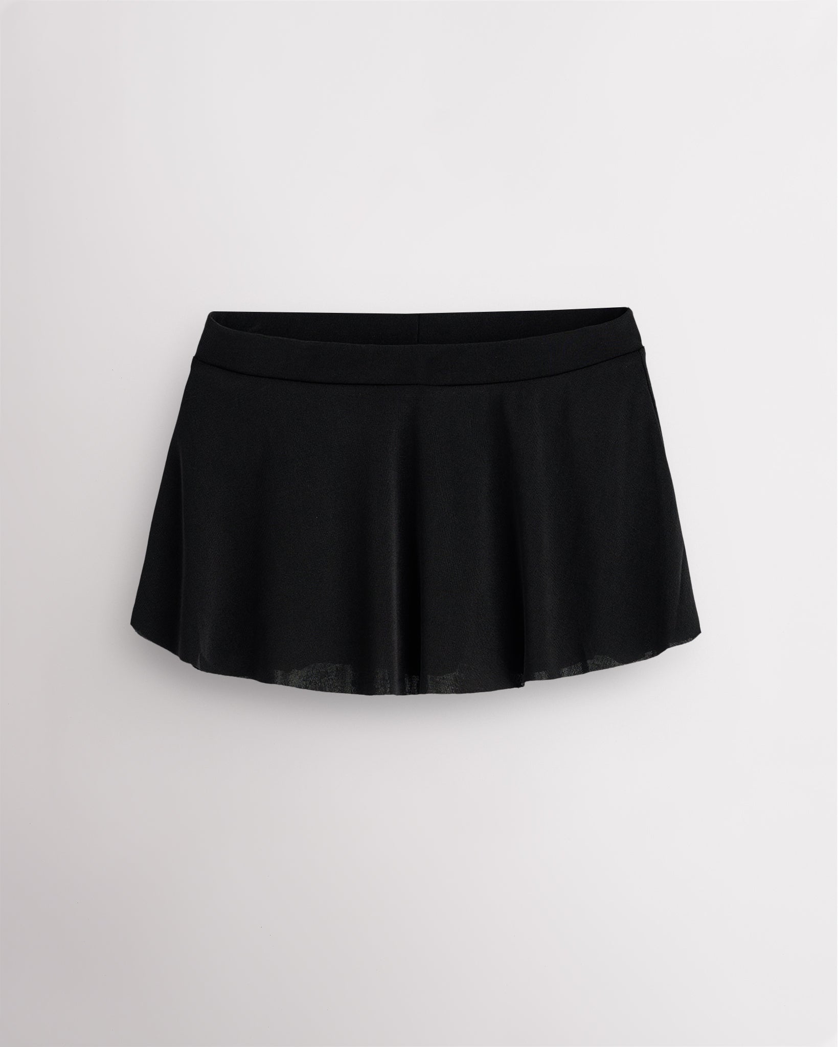 Black pull on dance skirt with high-low hem, lightweight flowing fabric, and subtle shimmer finish for elegant movement