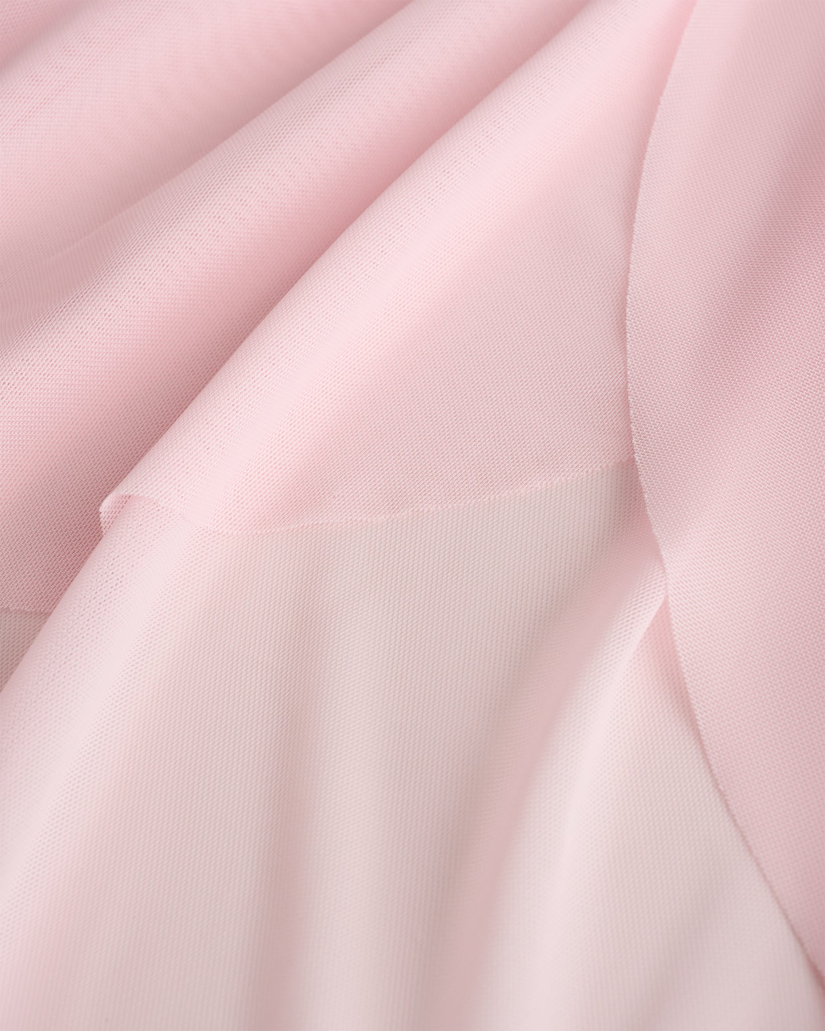 Close-up of pink dance skirt showing soft mesh fabric and graceful drape