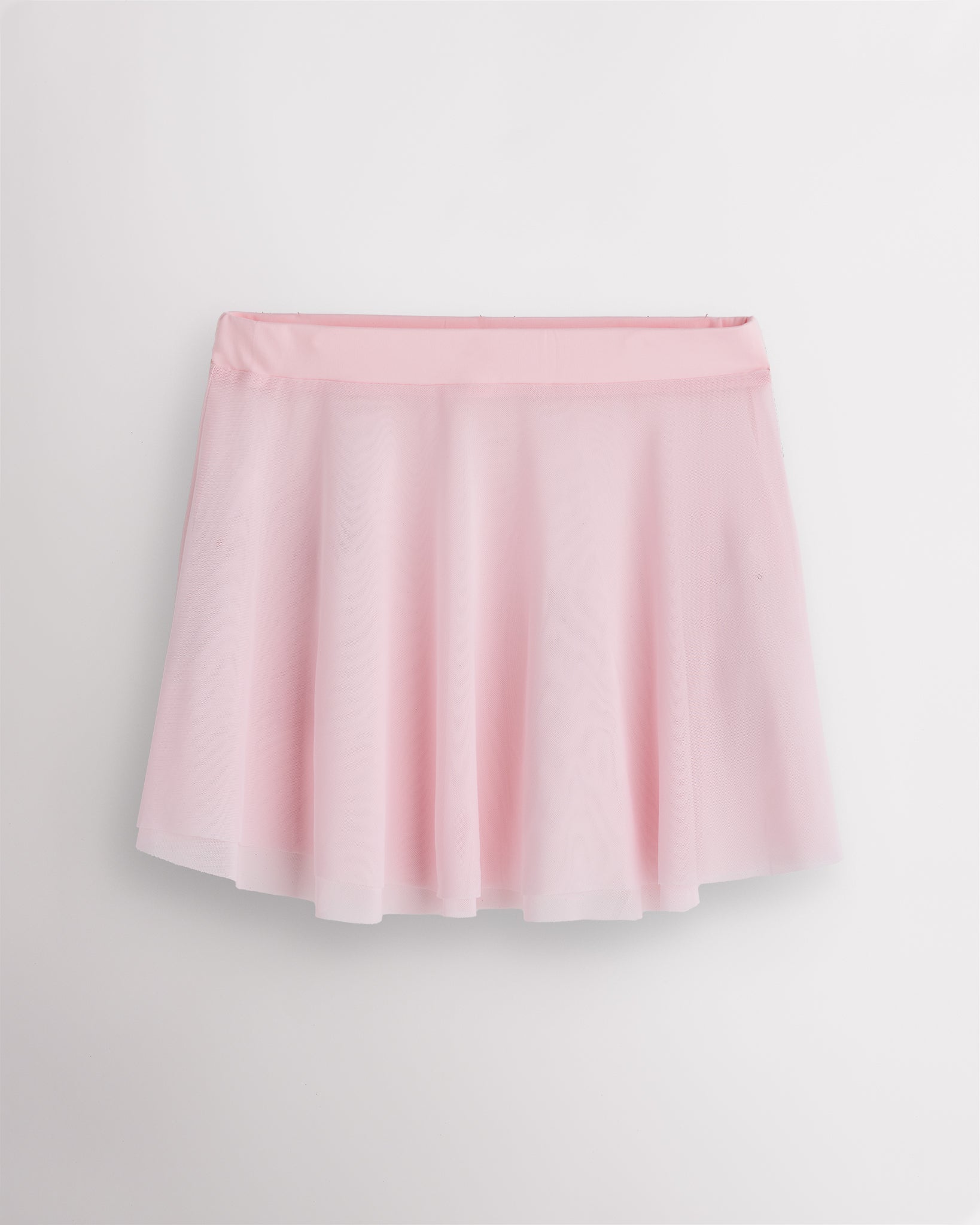 Ballet pink Stelle womens mesh dance skirt with elastic pull-on waistband, flared silhouette, and slightly longer back hem.