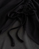 Close-up of black mesh ballet skirt showing adjustable ruched drawstring and soft sheer fabric.