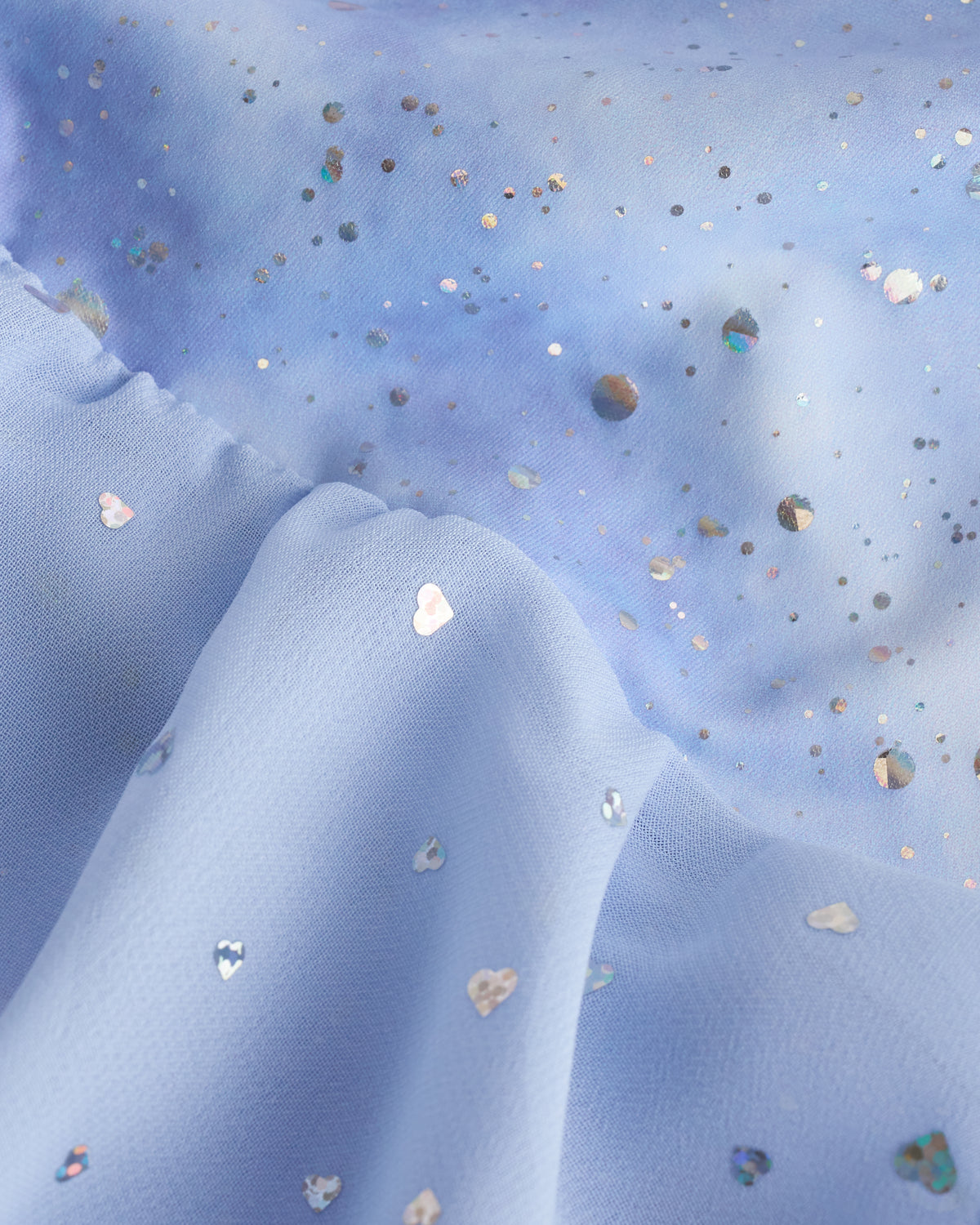 Close-up of Cloudburst Purple ballet dress fabric showing dreamy printed pattern, shimmer details, and sequins on the chiffon layers.