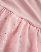 Close-up of ballet pink sequin dress showing heart-shaped sequins, chiffon skirt fabric, and gathered waist detail.