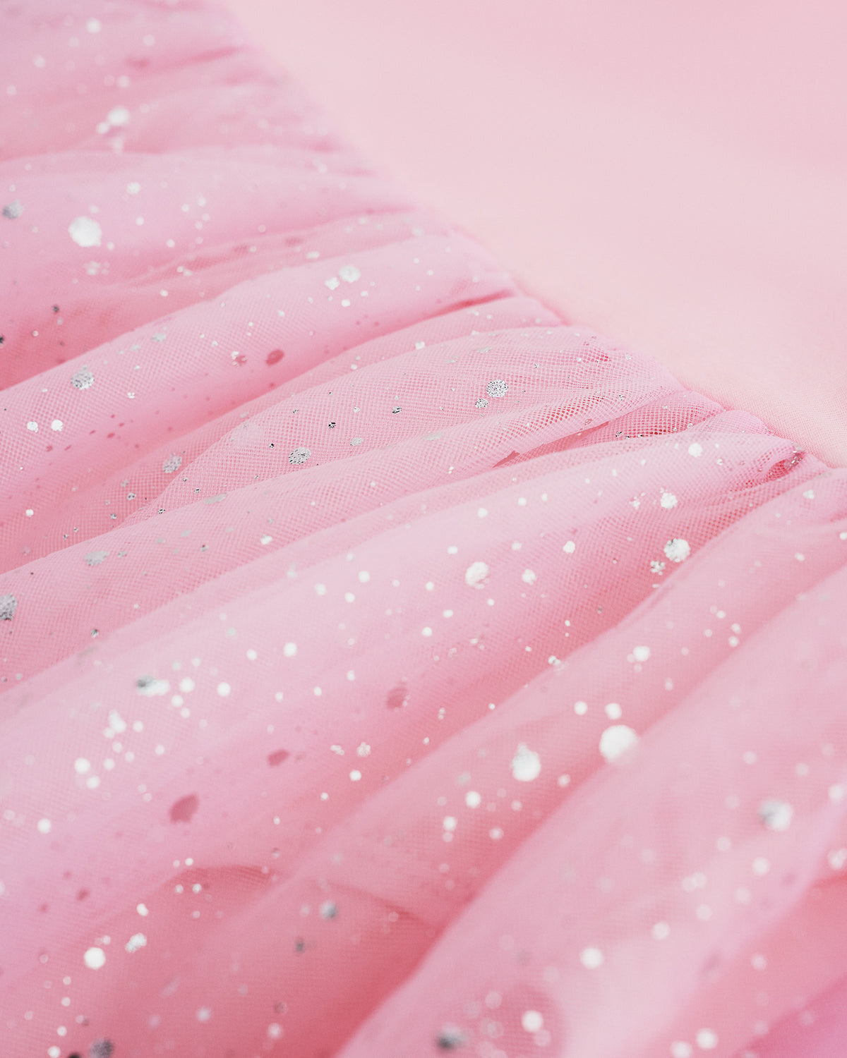 Close-up of Ballet Pink mesh skirt showing soft layered fabric and subtle shimmer details.