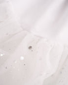 Close-up of White mesh skirt showing soft layered fabric and subtle shimmer details.