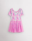 Back view of Bow Dreams dance ballet dress with short sleeves, crisscross back detail, shimmering print, and attached skirt.