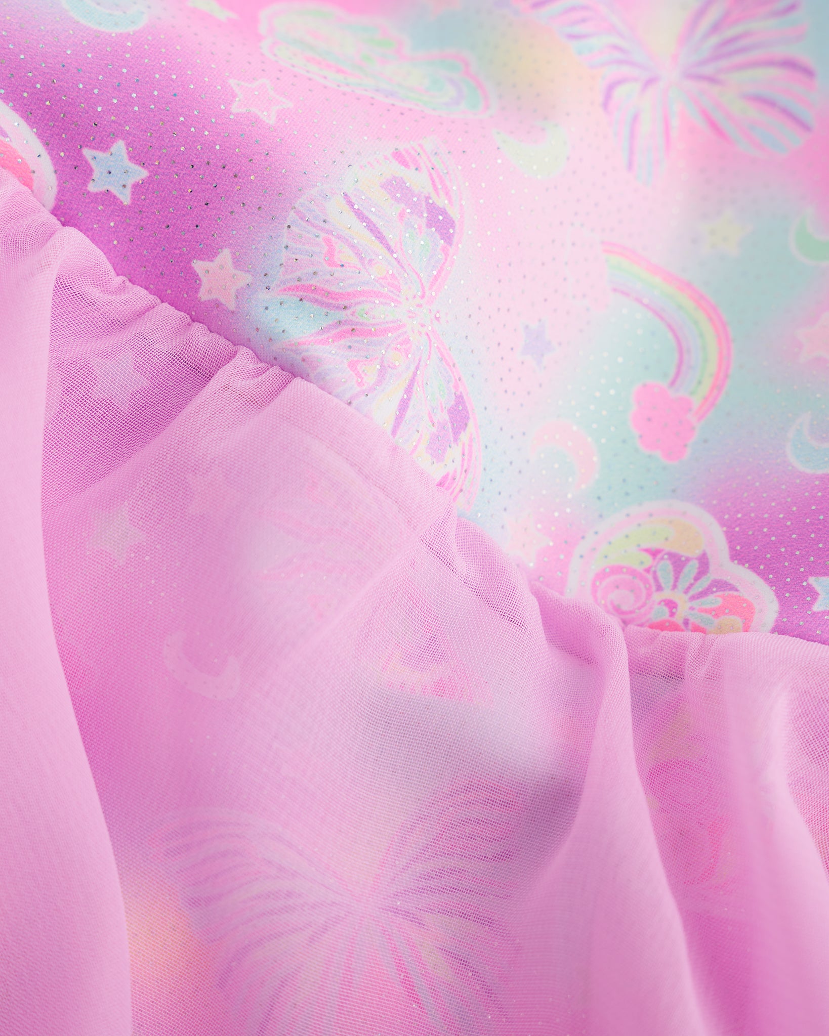 Close-up of Bow Dreams ballet dress showing the pink shimmering print and lightweight skirt fabric.