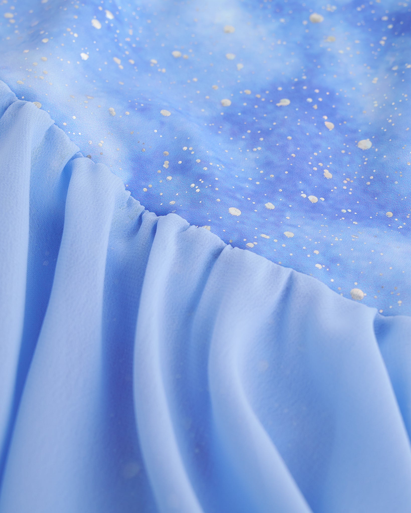 Close-up of Cloudburst Purple ballet dress showing shimmering print and gathered skirt fabric.