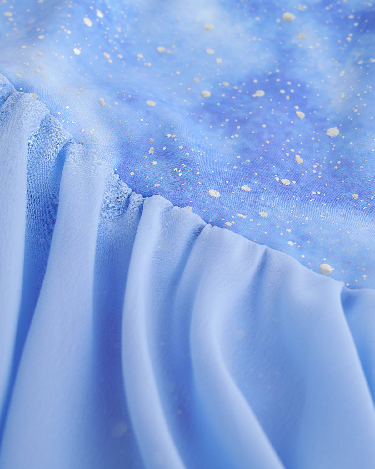 Close-up of Cloudburst Purple ballet dress showing shimmering print and gathered skirt fabric.