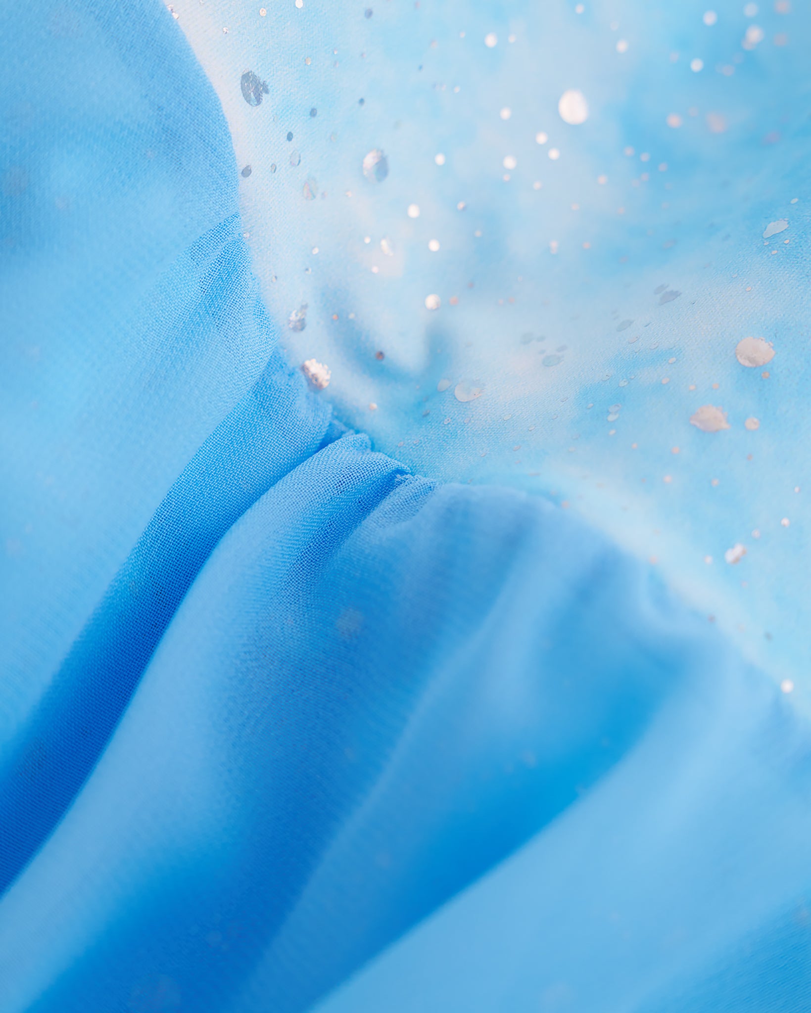 Close-up of Cloudburst Blue ballet dress showing the shimmering butterfly print and soft gathered lavender skirt fabric.